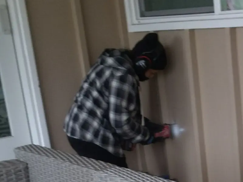 Professional electrician installing an exterior outlet in Signal Hill